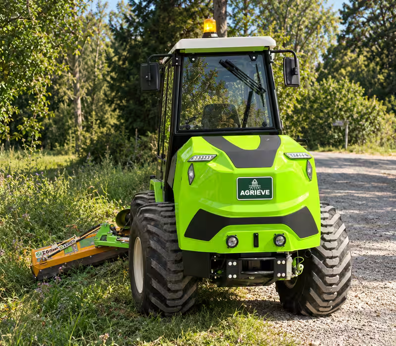 EVO3 electric tractor with a mowing attachment on a rural road